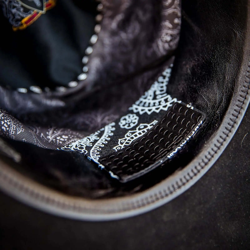 Close up of the Black Paisley Hat Cinch installed in a black felt cowboy hat