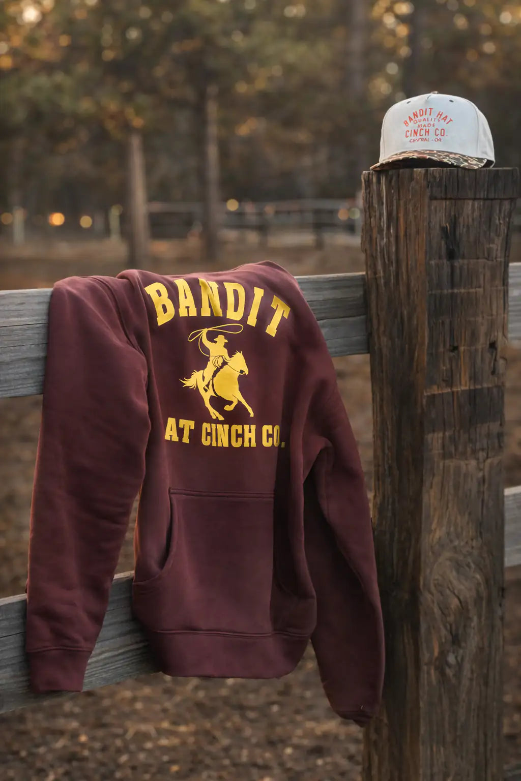 Classic brown hooded sweatshirt with yellow bandit and rider paired with a camo Bandit cap